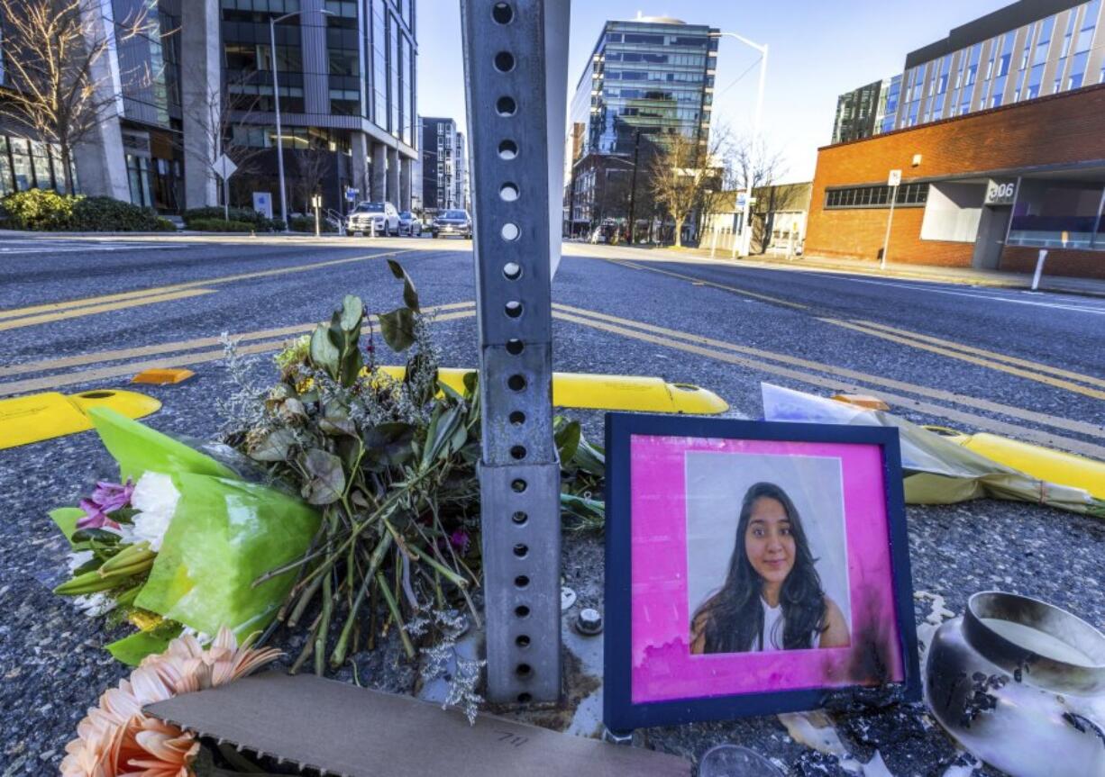 FILE - A photo of Jaahnavi Kandula is displayed with flowers, Jan. 29, 2023, in Seattle. Seattle&rsquo;s Office of Police Accountability said Tuesday, Jan. 23, 2024, that Seattle police officer Daniel Auderer violated policing standards when he made callous remarks about the death of Kandula, a woman from India who was struck by another officer&rsquo;s vehicle in a crosswalk in 2023.