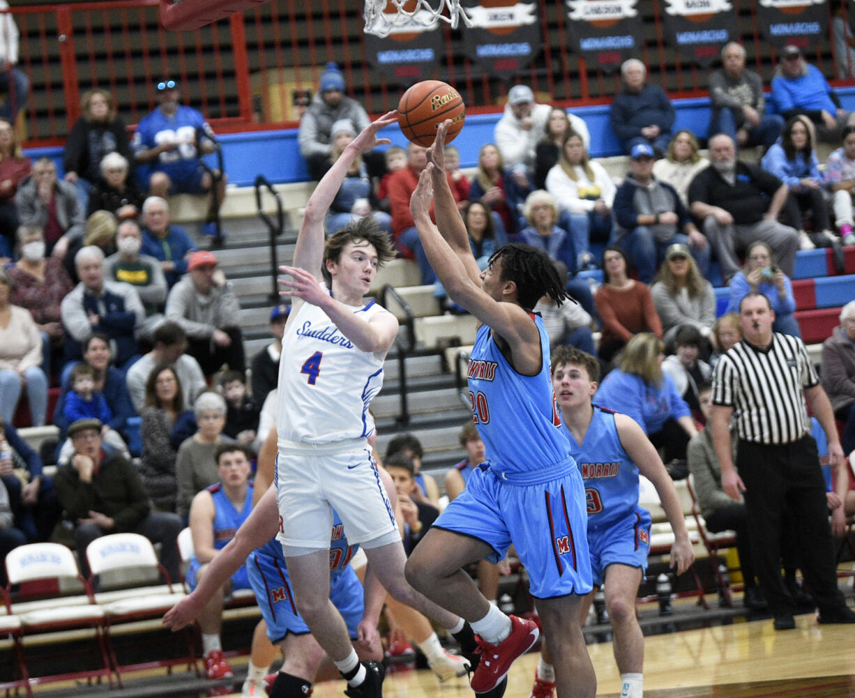 Cole Chester of Ridgefield (4) flips a pass over Dalton Stevens of Mark Morris in a 2A Greater St. Helens League boys basketball game at Mark Morris High School on Saturday, January 20, 2024.