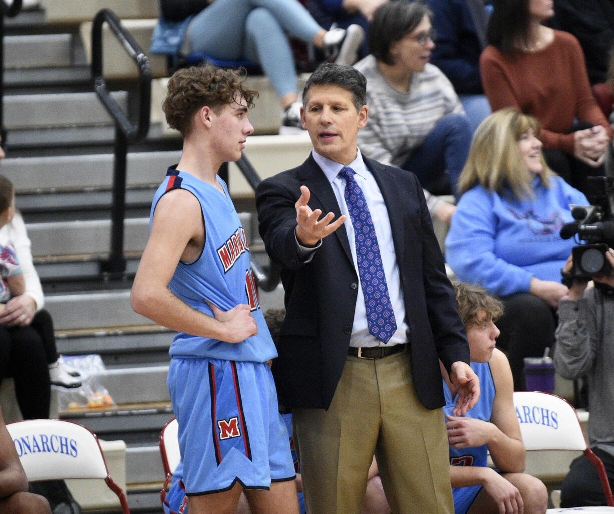 Mark Morris head coach Bill Bakamus talks to Braydon Olson during a 2A Greater St. Helens League boys basketball game against Ridgefield at Mark Morris High School on Saturday, January 20, 2024.