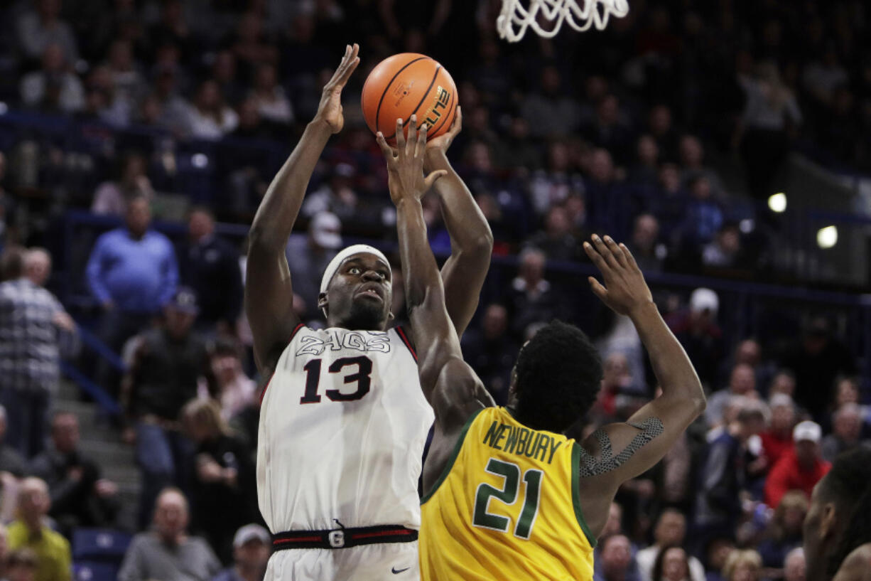 Gonzaga forward Graham Ike (13) shoots over San Francisco forward Ndewedo Newbury (21) during the second half of an NCAA college basketball game Thursday, Jan. 25, 2024, in Spokane, Wash. Gonzaga won 77-72.