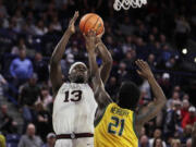 Gonzaga forward Graham Ike (13) shoots over San Francisco forward Ndewedo Newbury (21) during the second half of an NCAA college basketball game Thursday, Jan. 25, 2024, in Spokane, Wash. Gonzaga won 77-72.