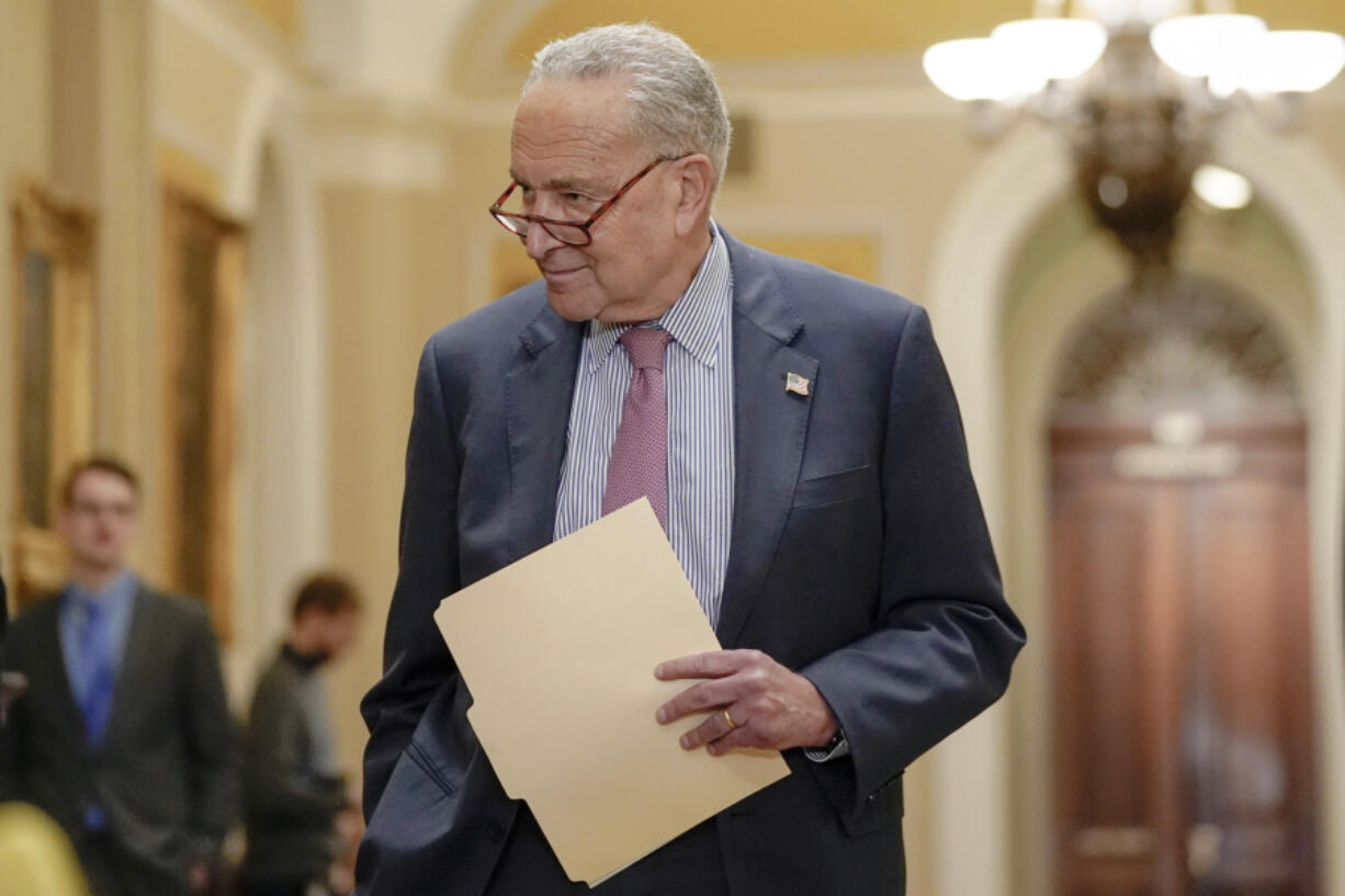 Sen. Majority Leader Chuck Schumer of N.Y., arrives to speak with reporters after a policy luncheon on Capitol Hill Tuesday, Jan. 9, 2024, in Washington.