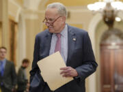 Sen. Majority Leader Chuck Schumer of N.Y., arrives to speak with reporters after a policy luncheon on Capitol Hill Tuesday, Jan. 9, 2024, in Washington.