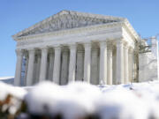 The U.S. Supreme Court is photographed through snow on Wednesday, Jan. 17, 2024, in Washington.