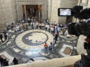 FILE - Protesters gather inside the State Capitol building on Friday, May 19, 2023, in Lincoln, Neb., before lawmakers were scheduled to begin debating a bill that will ban abortions at 12 weeks of pregnancy and also ban gender-affirming care for transgender minors.