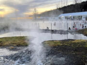 This Nov. 16, 2023 image provided by Beth Harpaz shows steam emanating from hot springs that supply geothermally heated water for the Secret Lagoon in the Hverah&oacute;lmi geothermal area off Iceland&rsquo;s Golden Circle route. The lagoon&rsquo;s outdoor pool is open year-round with water heated to just over 100 F (38-40 C).