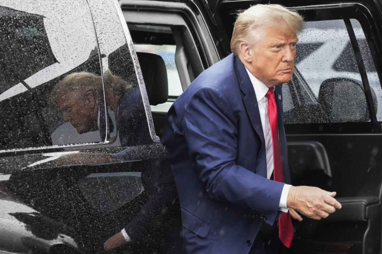 FILE - Former President Donald Trump arrives to board his plane at Ronald Reagan Washington National Airport, Aug. 3, 2023.