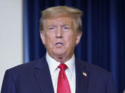 Former President Donald Trump speaks to the media at a Washington hotel, Tuesday, Jan. 9, 2024, after attending a hearing before the D.C. Circuit Court of Appeals at the federal courthouse in Washington.