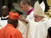 FILE - Cardinal Fridolin Among Besungu receives the red three-cornered biretta hat from Pope Francis during a consistory inside St. Peter&rsquo;s Basilica, at the Vatican, Oct. 5, 2019. In the greatest rebuke of Pope Francis yet, the Catholic hierarchy of Africa and Madagascar issued a unified statement Thursday, Jan.