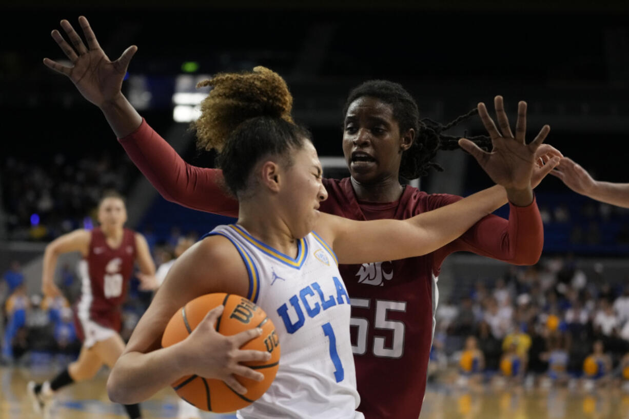 Washington State center Bella Murekatete, right, defends against UCLA guard Kiki Rice during the second half of an NCAA college basketball game, Sunday, Jan. 28, 2024, in Los Angeles.