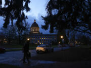 A person crosses the street in front of the Washington state Capitol building, Tuesday, Jan. 9, 2024, in Olympia, Wash.