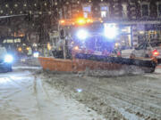 A plow from the Brattleboro, Vt., Public Works Department removes snow on Main Street on Tuesday, Jan. 9, 2024.