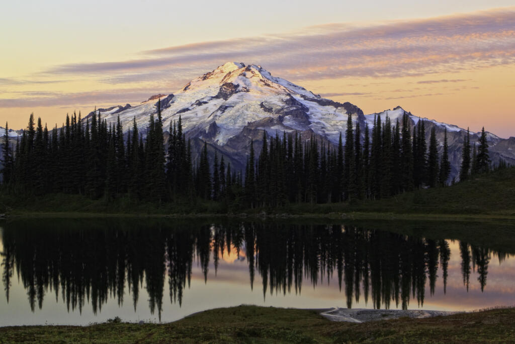 The sun rises over Glacier Peak and Image Lake in the Cascades.