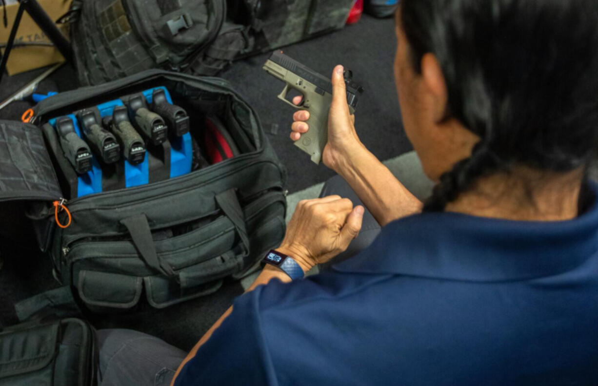 Tom Nguyen, founder of LA Progressive Shooters, prepares to teach his Pistol 101 Safety &amp; Fundamentals class Oct. 29, in Norwalk, Calif.