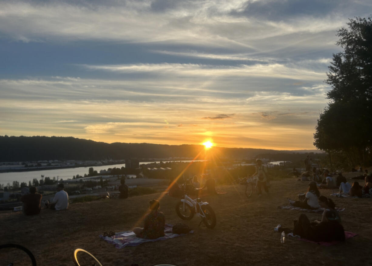 The sun sets over Mock’s Crest viewpoint in Portland. An Oregon bill would lead to earlier sunsets in the summer.