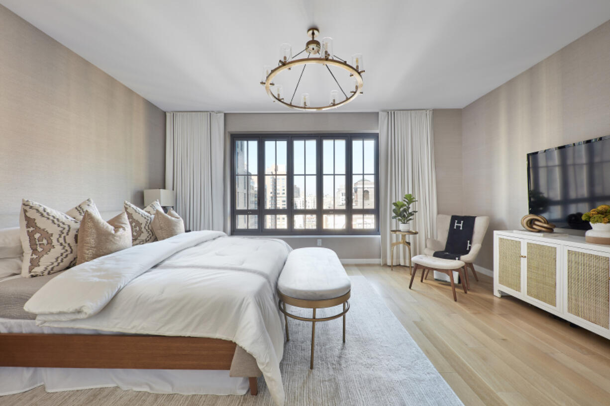 A bench adds a finishing touch in this bedroom.