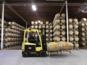 In this photo taken Thursday, Nov. 21, 2019, barrels of wine are moved into storage at Chateau Ste. Michelle winery in Woodinville.