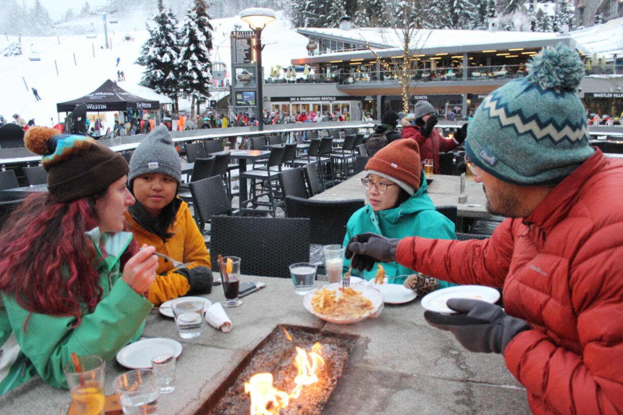 Whistler Blackcomb draws visitors from near and far, like this group from Atlanta enjoying apres food and drinks at the Longhorn Pub after a day of skiing.