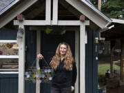 Artist Kristin Culotta takes a break outside her rural Camas studio with a free-form hexagon panel. Many of her works are custom. &ldquo;I love collaborating with clients on projects in every aspect of the process,&rdquo; Culotta said.