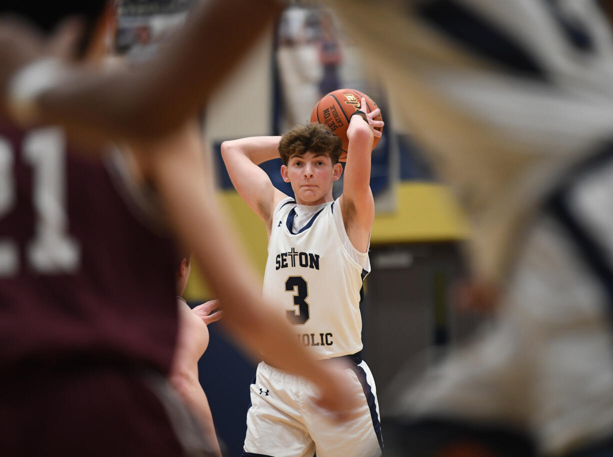 Seton Catholic junior Brady Angelo looks for an open teammate Friday, Feb. 9, 2024, during the Cougars’ 58-46 win against Montesano at Seton Catholic High School.