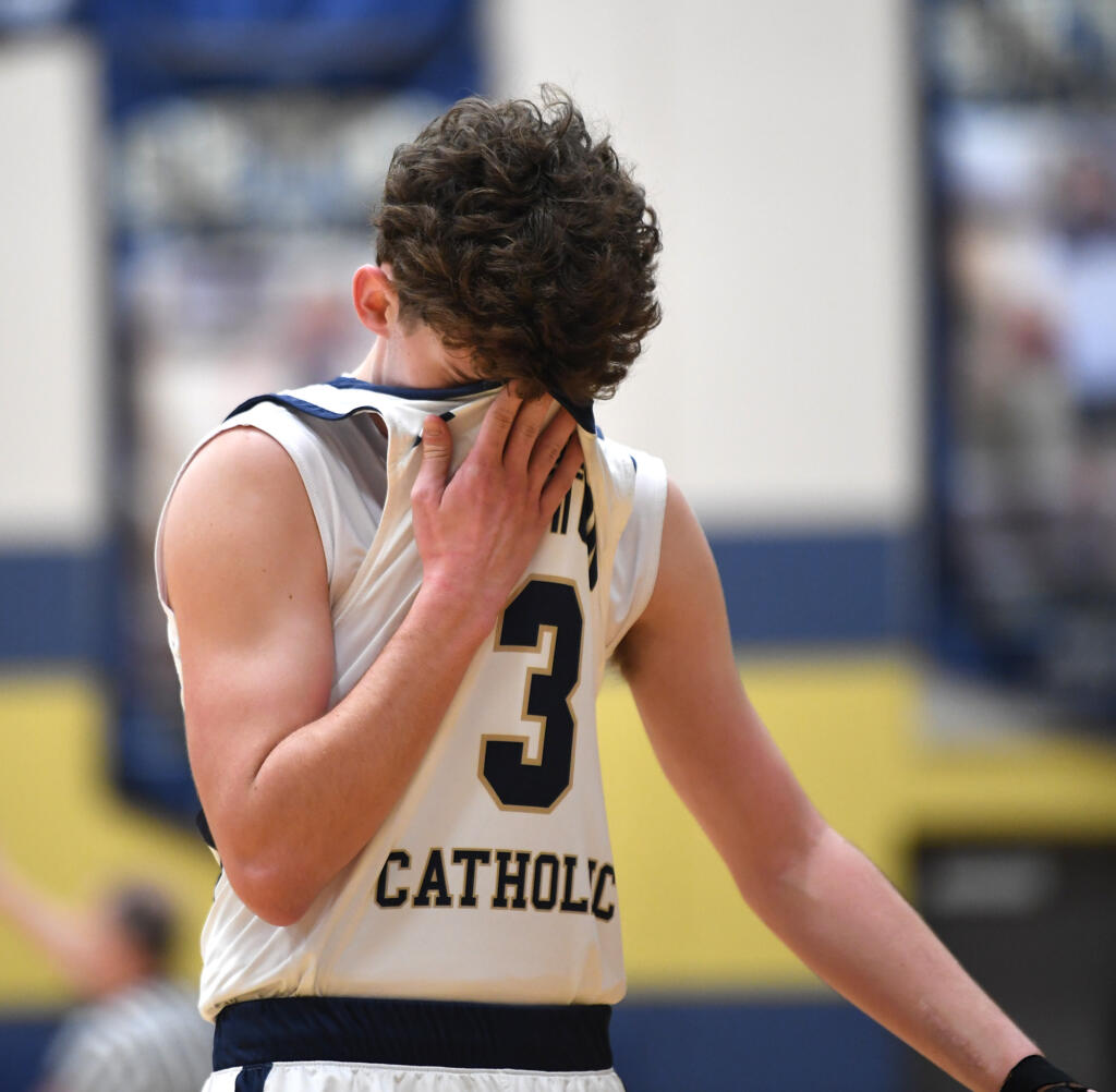 Seton Catholic junior Brady Angelo wipes away sweat Friday, Feb. 9, 2024, during the Cougars’ 58-46 win against Montesano at Seton Catholic High School.