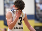 Seton Catholic junior Brady Angelo wipes away sweat Friday, Feb. 9, 2024, during the Cougars’ 58-46 win against Montesano at Seton Catholic High School.