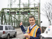 U.S. Department of Transportation Secretary Pete Buttigieg holds a cupcake celebrating the 107th birthday of the Interstate 5 Bridge on Feb. 13 in Vancouver.