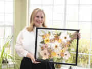 Daphne Andersons holds a completed, framed bouquet. Her business, Vancuterie, offers bridal bouquet preservation using ancient Japanese flower-pressing techniques.