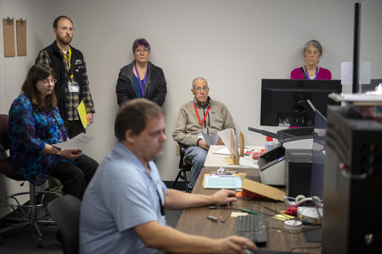 Observers look on as election coordinator Robert Easterly, foreground, conducts logic and accuracy tests before the March 12 presidential primary at the Clark County Elections Office. &ldquo;It&rsquo;s a proofing process that makes sure that everything&rsquo;s correct,&rdquo; Clark County Elections Director Cathie Garber said.