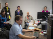 Observers look on as election coordinator Robert Easterly, foreground, conducts logic and accuracy tests before the March 12 presidential primary at the Clark County Elections Office. &ldquo;It&rsquo;s a proofing process that makes sure that everything&rsquo;s correct,&rdquo; Clark County Elections Director Cathie Garber said.