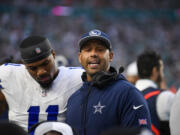 Dallas Cowboys coach Aden Durde talks to his players during the first half of an NFL football game against the Miami Dolphins, Sunday, Dec. 24, 2023, in Miami Gardens, Fla.