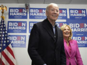 President Joe Biden, left, waits to speak as first lady Jill Biden looks on at the Biden campaign headquarters in Wilmington, Del., Saturday, Feb. 3, 2024.