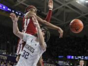 Washington State forward Isaac Jones blocks a shot attempt by Washington forward Wilhelm Breidenbach during the first half of an NCAA college basketball game, Saturday, Feb. 3, 2024 in Seattle.