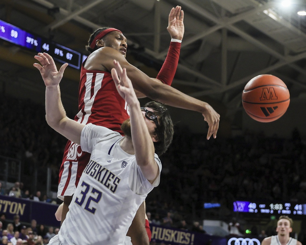 Washington State forward Isaac Jones blocks a shot attempt by Washington forward Wilhelm Breidenbach during the first half of an NCAA college basketball game, Saturday, Feb. 3, 2024 in Seattle.