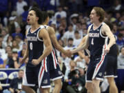 Gonzaga's Ryan Nembhard (0) and Dusty Stromer (4) celebrate the team's win over Kentucky in an NCAA college basketball game Saturday, Feb. 10, 2024, in Lexington, Ky.