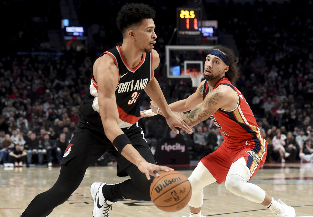 Portland Trail Blazers forward Toumani Camara, left, drives against New Orleans Pelicans guard Jose Alvarado during the first half of an NBA basketball game in Portland, Ore., Saturday Feb. 10, 2024.