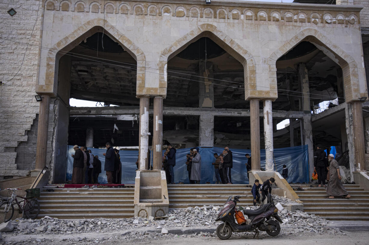 Palestinians pray in a damaged mosque following an Israeli strike in Rafah, southern Gaza Strip, Thursday, Feb. 15, 2024.