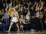 Iowa guard Caitlin Clark (22) reacts after breaking the NCAA women's career scoring record during the first half of the team's college basketball game against Michigan, Thursday, Feb. 15, 2024, in Iowa City, Iowa.