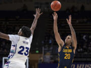 California guard Jaylon Tyson shoots the ball against Washington guard Anthony Holland during the first half of an NCAA college basketball game Saturday, Feb. 17, 2024, in Seattle.