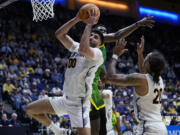 California forward Fardaws Aimaq (00) rebounds the ball during the second half of the team's NCAA college basketball game against Oregon, Saturday, Feb. 24, 2024, in Berkeley, Calif. (AP Photo/Godofredo A.