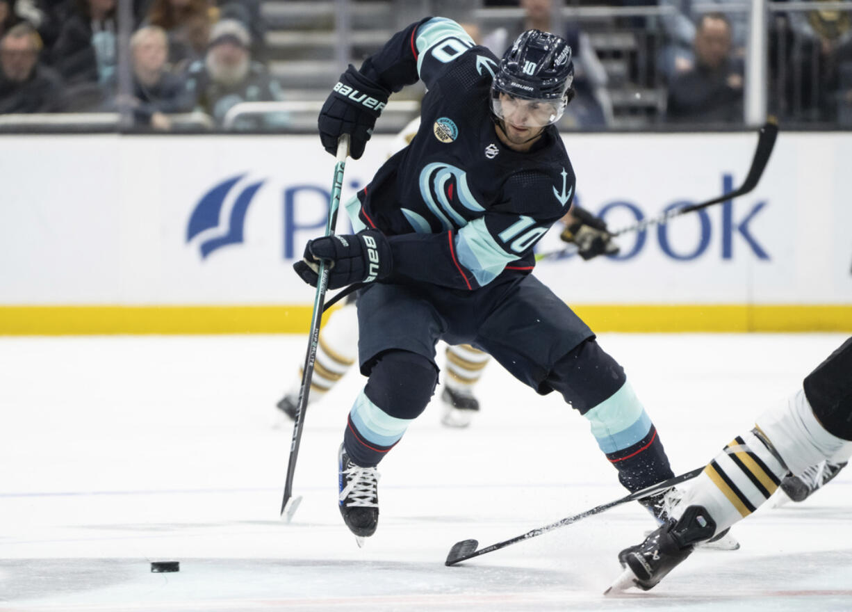 Seattle Kraken forward Matty Beniers skates with the puck against the Boston Bruins during the second period of an NHL hockey game, Monday, Feb. 26, 2024, in Seattle.