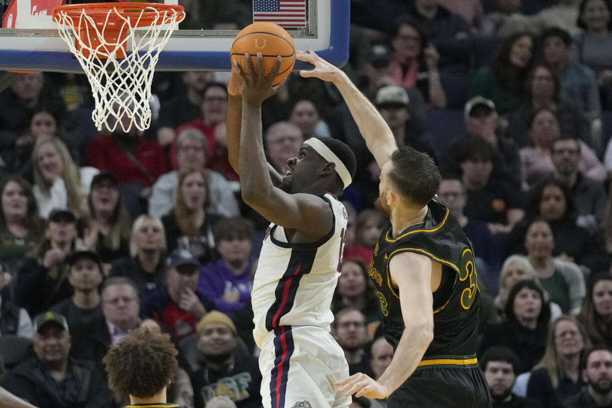 Gonzaga forward Graham Ike, top left, shoots against San Francisco center Volodymyr Markovetskyy during the first half of an NCAA college basketball game in San Francisco, Thursday, Feb. 29, 2024.