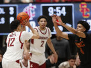 Washington State guard Isaiah Watts (12) prepares to shoot against Southern California guard Oziyah Sellers (4) during the second half of an NCAA college basketball game Thursday, Feb. 29, 2024, in Pullman, Wash.