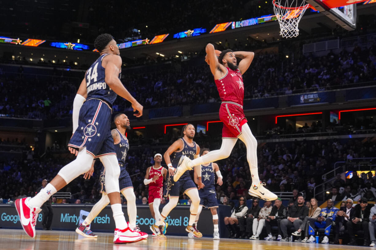 Minnesota Timberwolves forward Karl-Anthony Towns (32) goes up for a dunk during the first half of an NBA All-Star basketball game in Indianapolis, Sunday, Feb. 18, 2024.