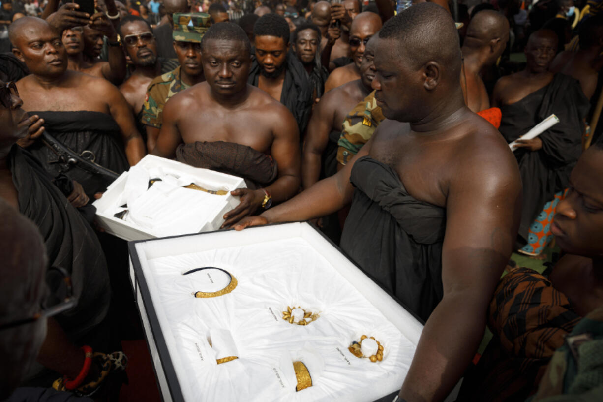 ArtIfacts returned from UCLA&rsquo;s Fowler Museum are carried to Asante King Otumfuo Osei Tutu II at the Manhyia Palace in Kumasi, Ghana, Thursday, Feb. 8, 2024. Seven royal artifacts which were looted by British forces from Ghana&rsquo;s ancient Asante kingdom in the 19th century were returned by the museum, the latest of a series of stolen treasured items now being repatriated to several African countries.