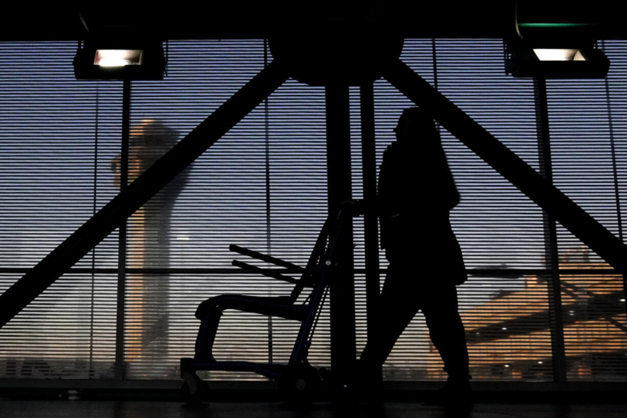 FILE - An airline employee transfers a wheelchair to her station at O&rsquo;Hare International Airport in Chicago, Nov. 23, 2022. The Biden administration will propose Thursday, Feb. 29, 2024, to make it easier for the government to fine airlines for damaging or misplacing wheelchairs by making it an automatic violation of a federal law on accessible air travel. (AP Photo/Nam Y.