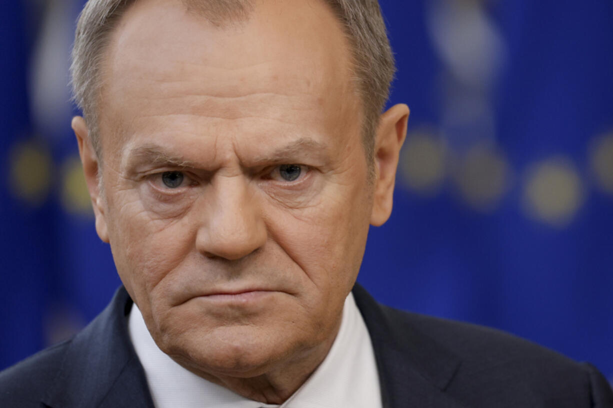 Poland&rsquo;s Prime Minister Donald Tusk listens to a question while talking to journalists as he arrives for an EU summit in Brussels, Thursday, Feb. 1, 2024. European Union leaders meet in Brussels for a one day summit to discuss the revision of the Multiannual Financial Framework 2021-2027, including support for Ukraine.