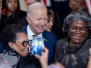 President Joe Biden takes a photograph with Housing and Urban Development Secretary Marcia Fudge, left, and United States Ambassador to the United Nations Linda Thomas-Greenfield, right, during a reception in recognition of Black History Month in the East Room of the White House in Washington, Tuesday, Feb. 6, 2024.