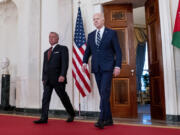 President Joe Biden, right, arrives with Jordan&#039;s King Abdullah II to speak in the Cross Hall of the White House, Monday, Feb. 12, 2024, in Washington.