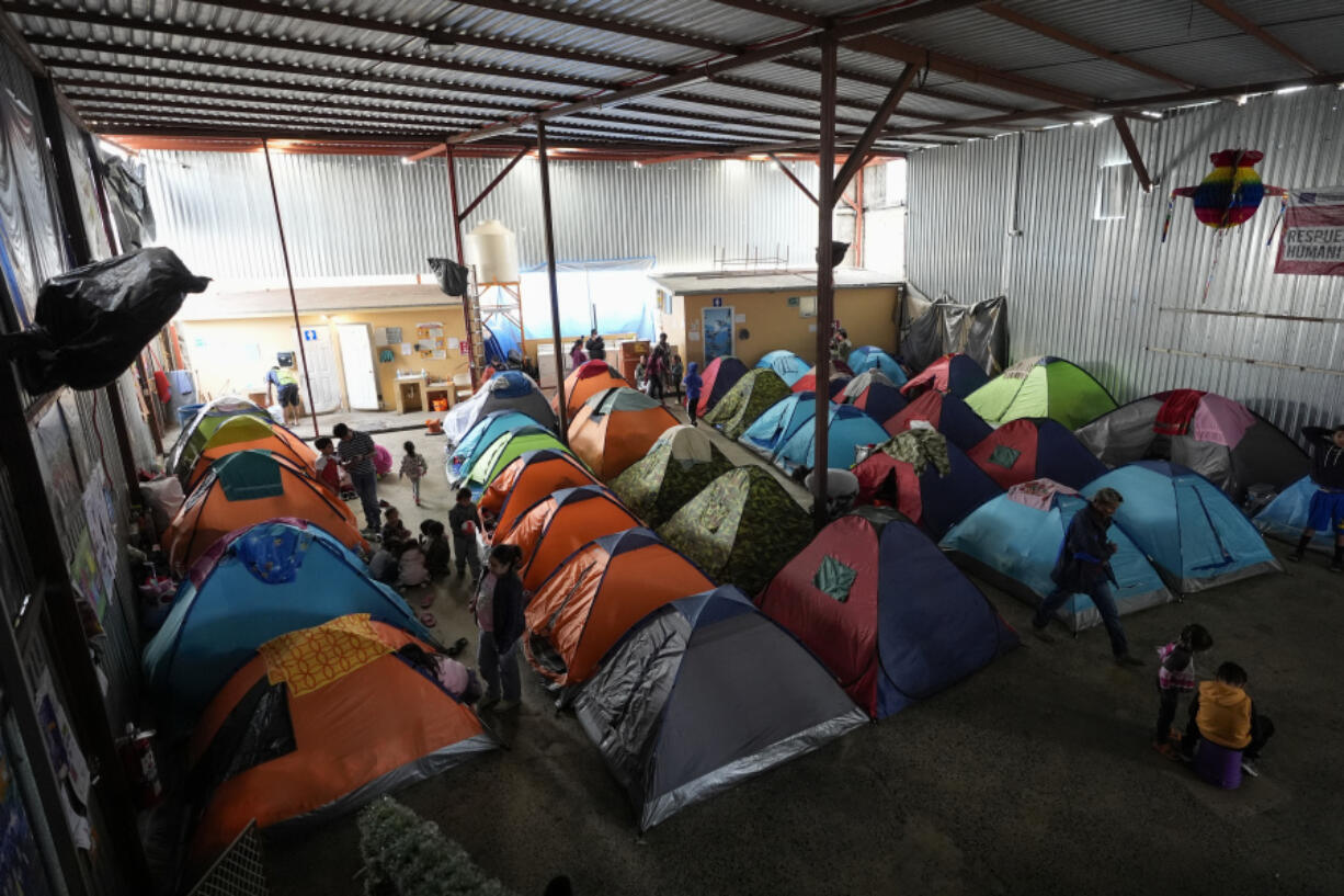 Asylum seekers wait for appointments through the CBP One app to apply for asylum in the United States in a shelter for migrants, Saturday, Feb. 3, 2024, in Tijuana, Mexico.